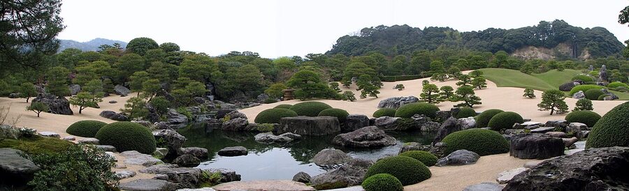 The carefully composed Adachi Museum of Art garden with pruned pines and a mountain backdrop