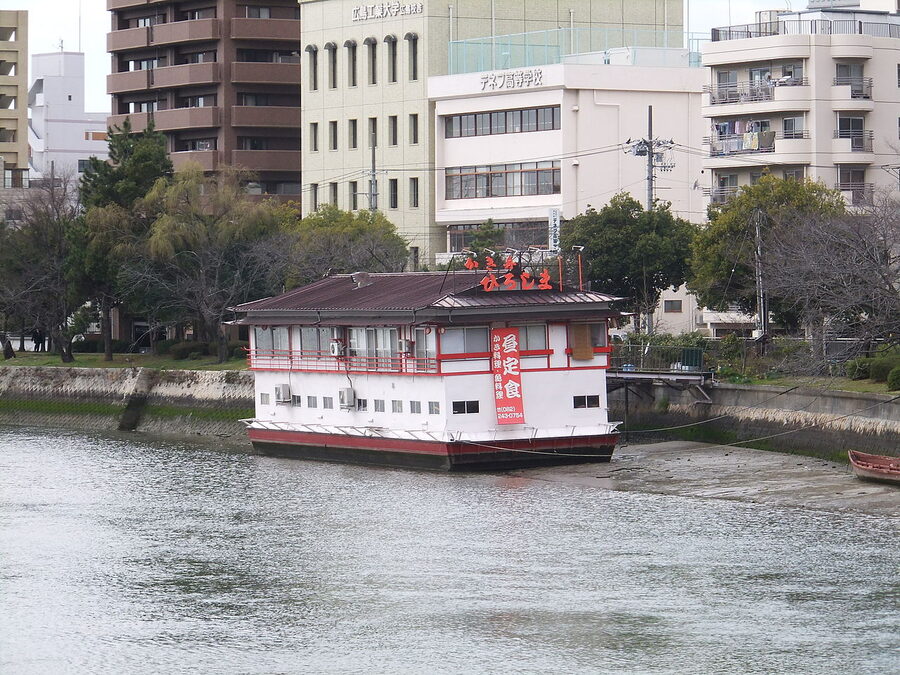A kakibune floating restaurant at sunset on a Hiroshima river