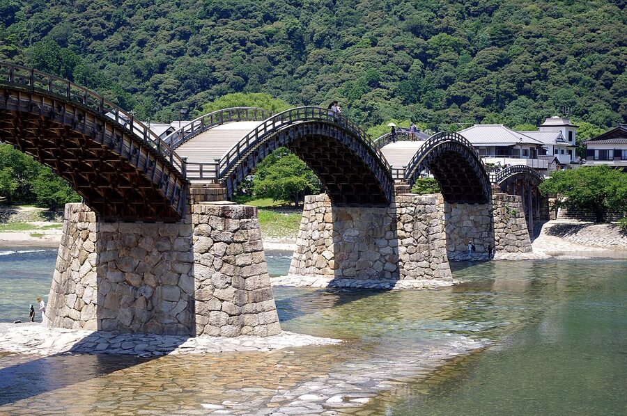 Wide view of the five wooden arches of the Kintaikyo Bridge over the Nishiki River
