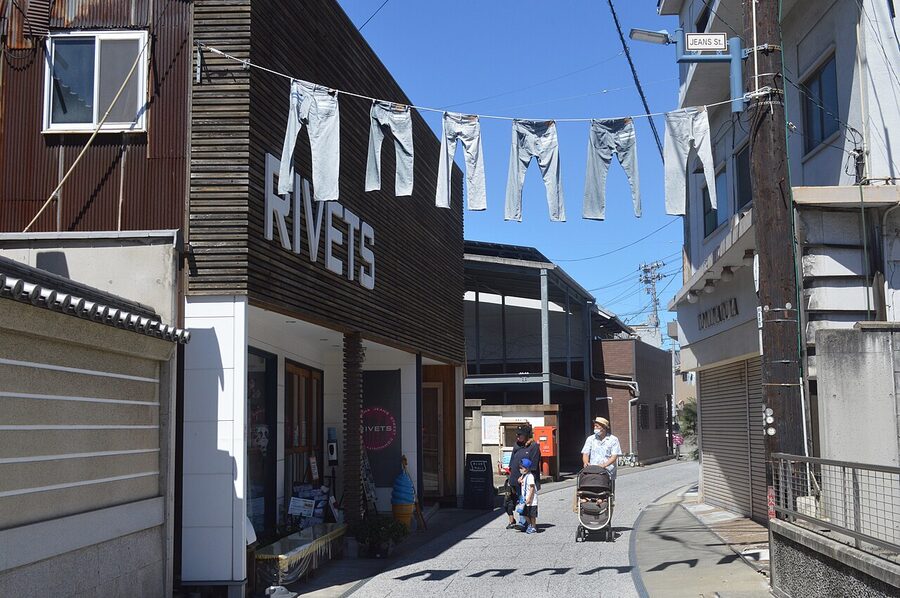 Kojima Jeans Street in Kurashiki with denim flags hanging between buildings