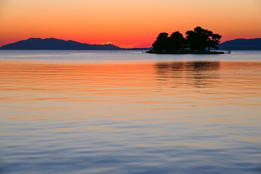 The small Yomegashima island rock silhouetted against a Lake Shinji sunset