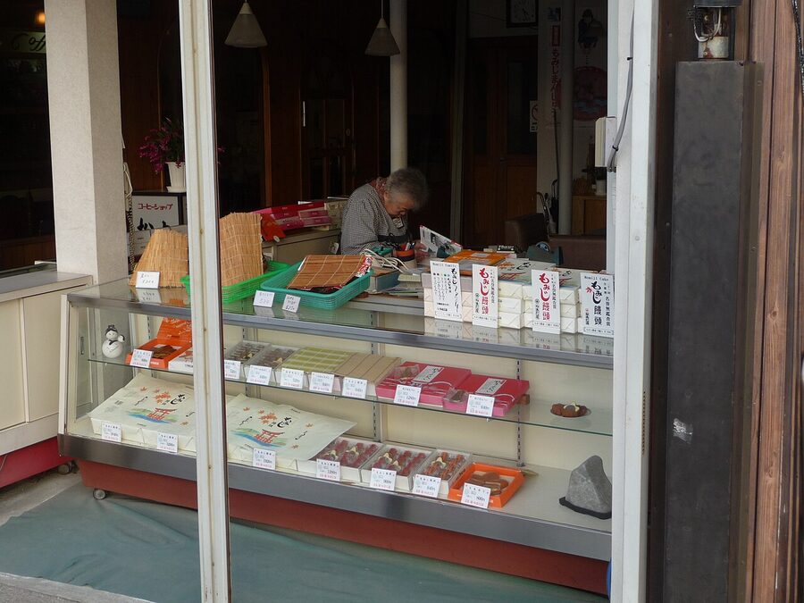 A traditional momiji manju sweet shop in Miyajima with display of maple-leaf shaped cakes