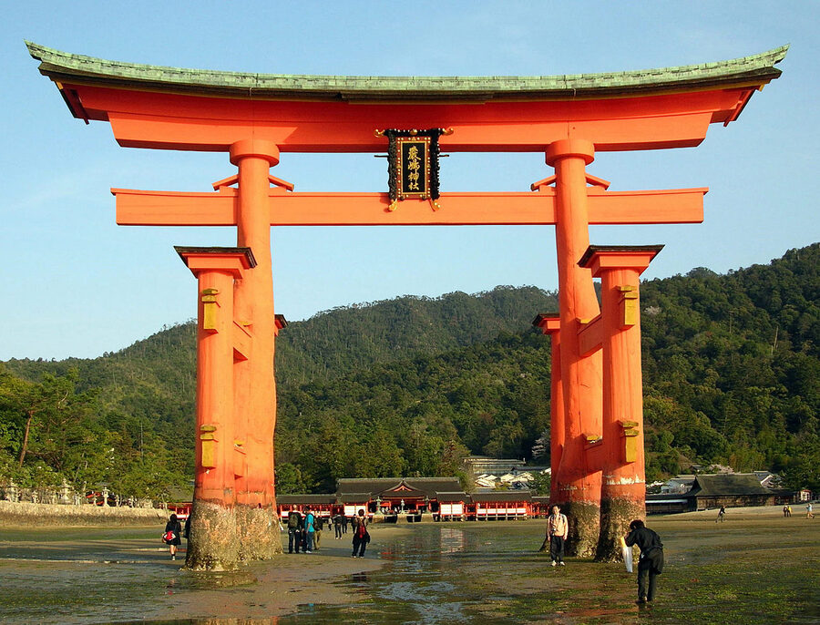 The wide view of Itsukushima Shrine with the floating torii in the bay