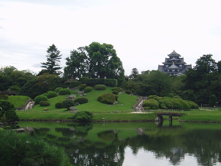 Korakuen garden in the foreground with Okayama Castle rising behind across the Asahi River