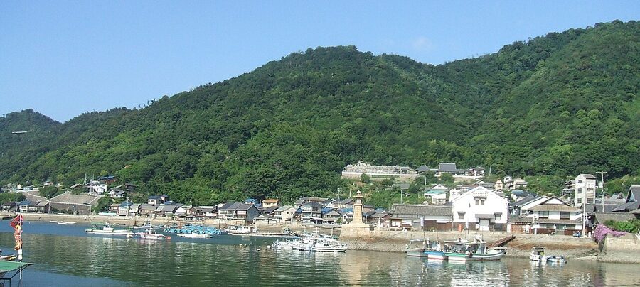 Wooden boats tied up at the old harbour wall in Tomonoura