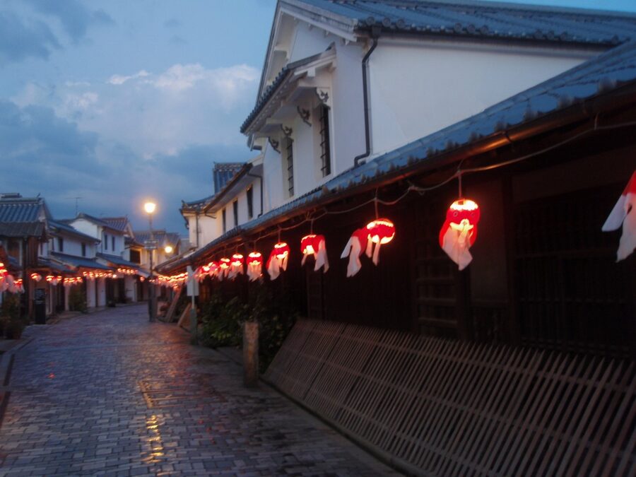 Goldfish lanterns illuminated in the evening light of Yanai