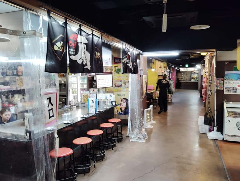 Hiroshima: 1-Hour Okonomiyaki Experience at Ekimae-Hiroba - Walking through the market before the meal