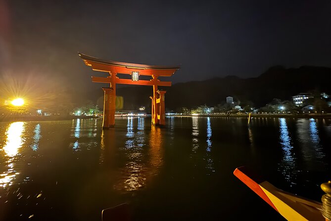 Miyajima Exploring Highlights and Sunset Cruise - The great red torii from the water